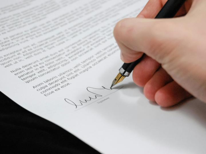 hand signing a paper