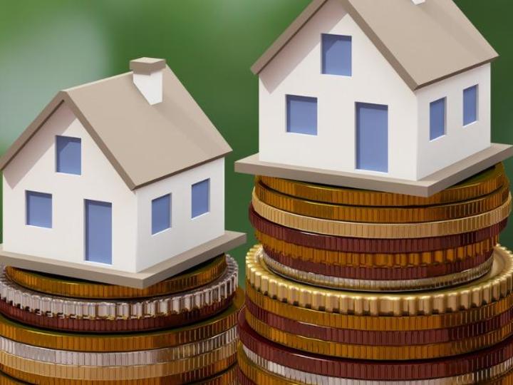 fake houses stacked on top of coins