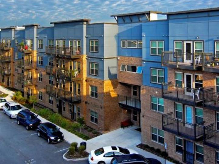 high rise apartment with cars around