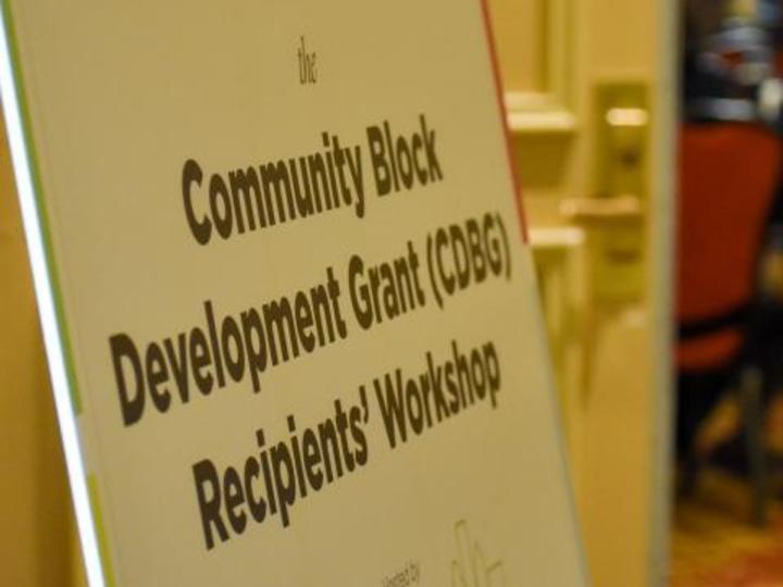 a sign that says "Community Block Development Grant Recipients' Workshop"