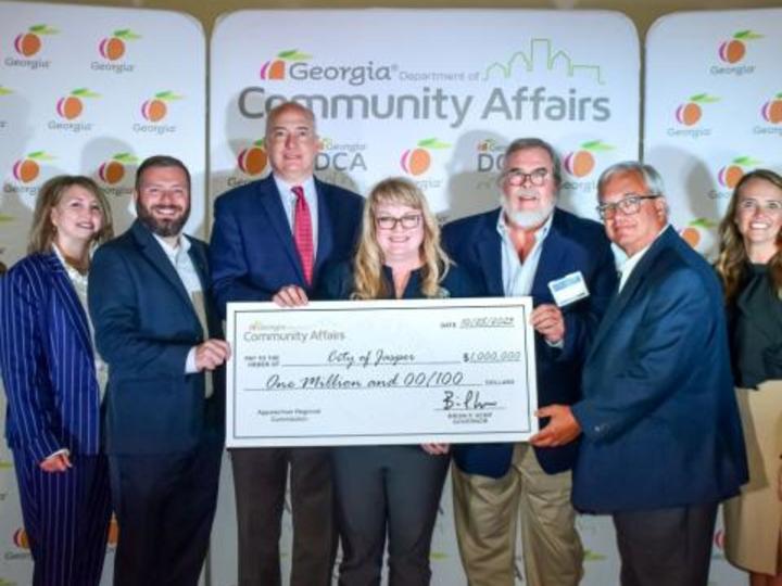 people holding a big check