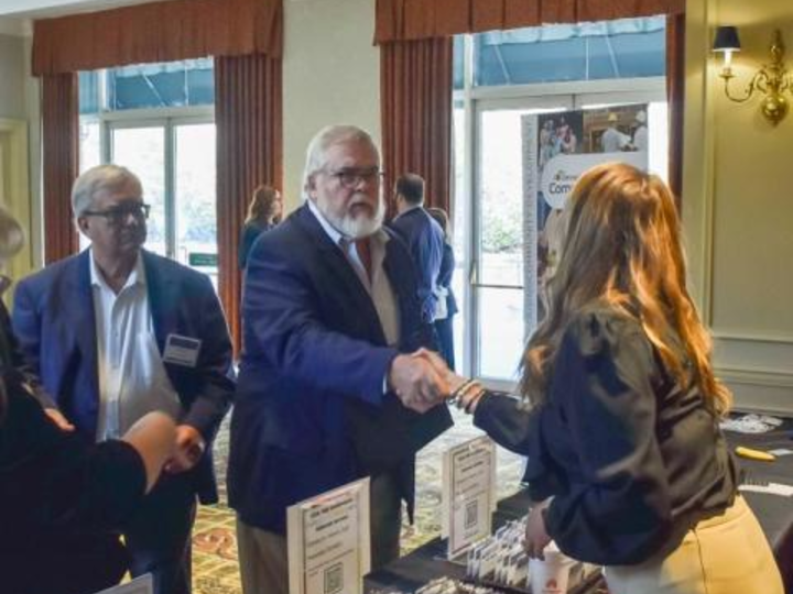 man shaking hands with a woman at a conference