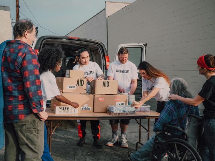 volunteers handing out food and supplies