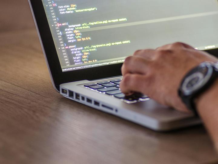 hands working on a laptop