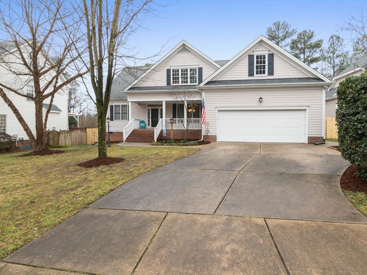 nice home with a driveway and american flag hanging