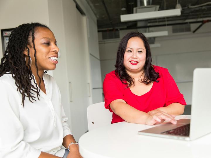 two women looking at a computer