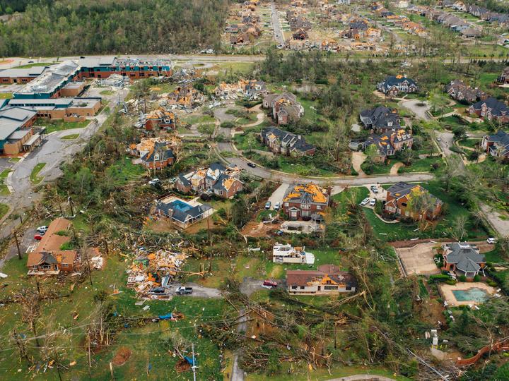 a neighborhood with tornado damage from arial view