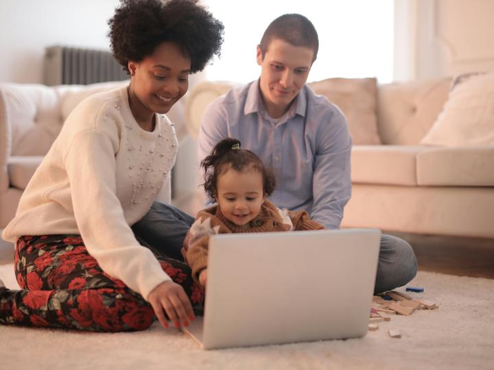 Family looking a computer.