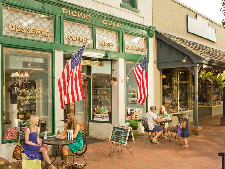 Customers sitting at round tables in front of a cafe in Dahlonega, GA
