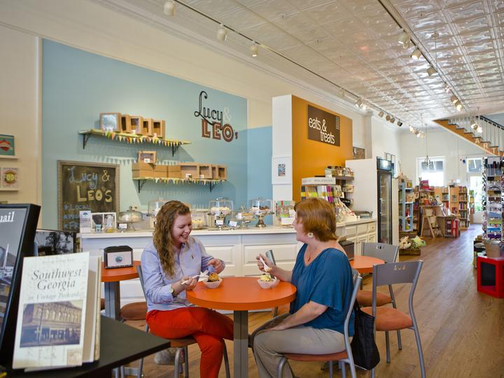 Two ladies sitting, enjoying sweet treats at a venue in Thomasville, GA.
