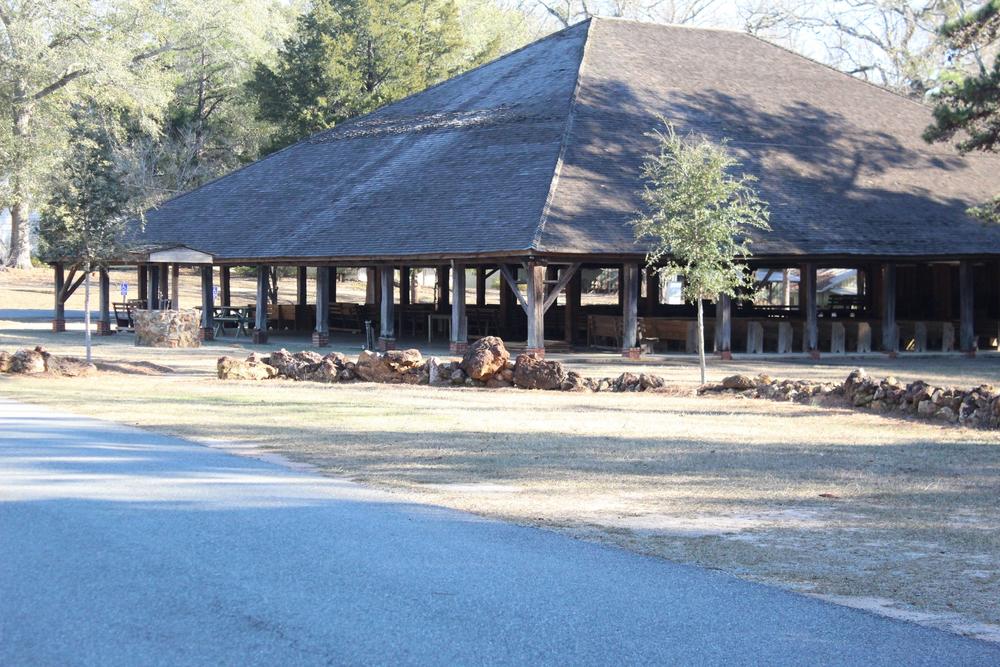 Open air wooden pavilion in wooded area