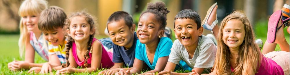 Image of children of around 7 years old, of various races and genders, smiling