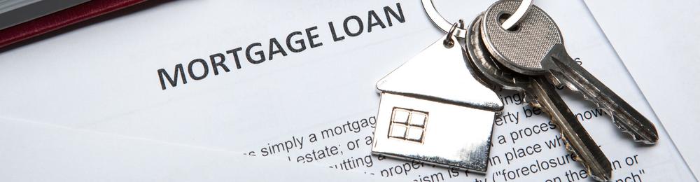 Mortgage loan papers with house keys