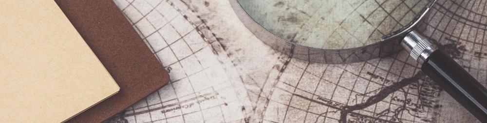 old map and magnifying glass