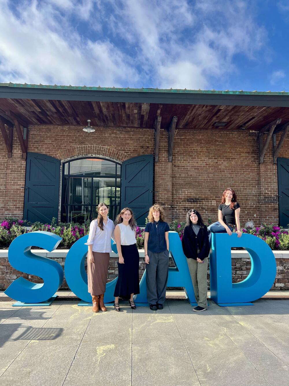 Students from the SCAD Historic Preservation Program pose in front of a historic building
